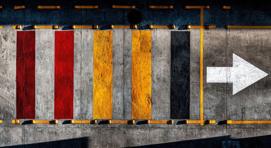 Color horizontal block on flooring with an arrow to support wayfinding