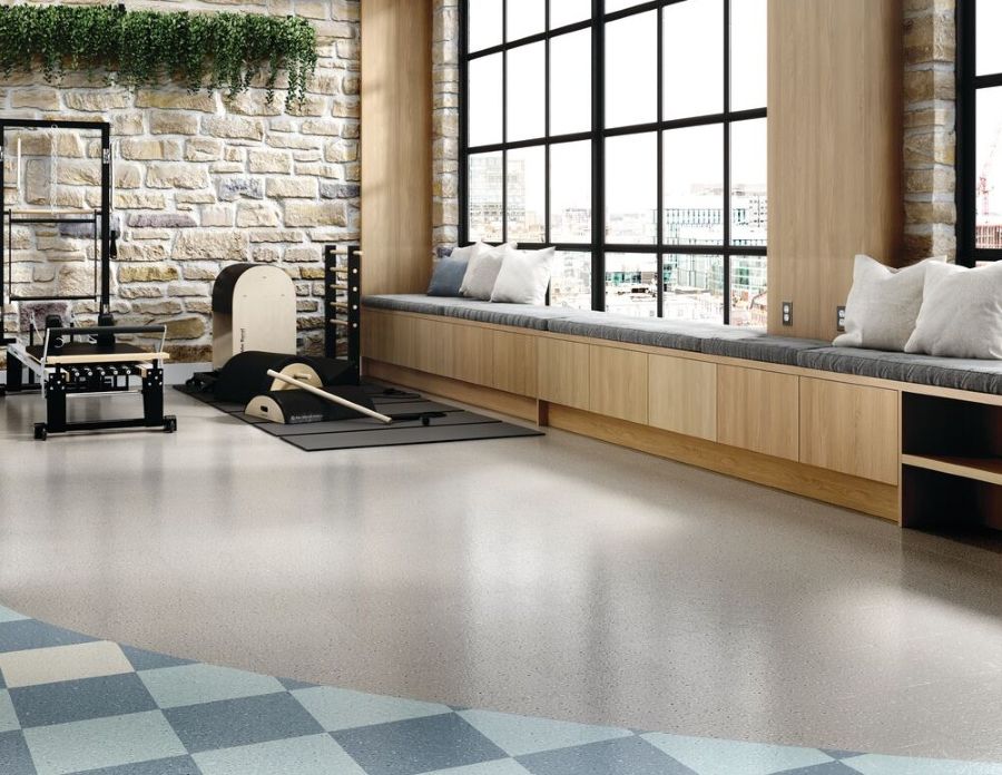 Workout area with checkboard and speckled VCT flooring