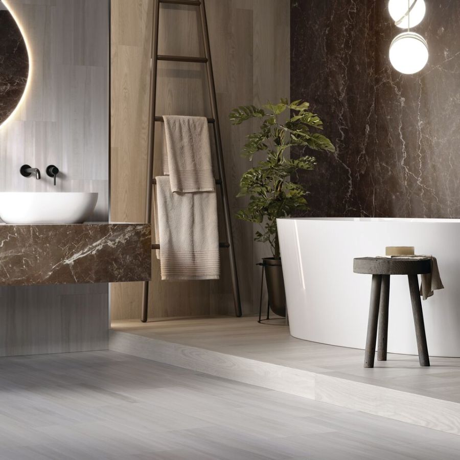 Bathroom with a tub and LVT on the walls and floor