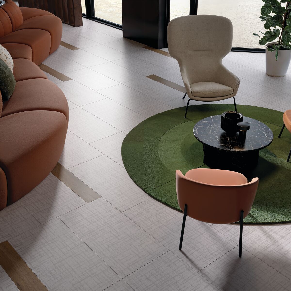 Seating area in a lobby with a table; commercial LVT flooring