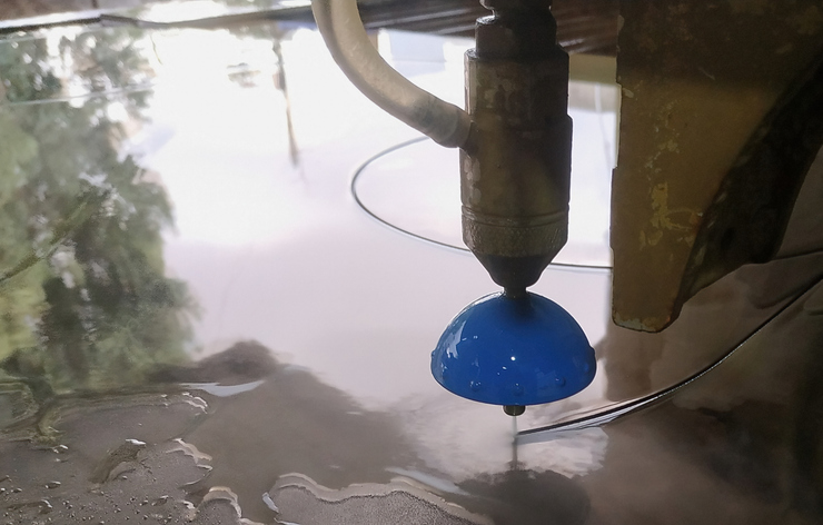 Closeup of a waterjet cutter in action